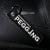 Black keychain with 'Begging for a Pegging' text on a textured black surface.