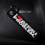 Keychain with 'I love being a problem' text on a black textured surface